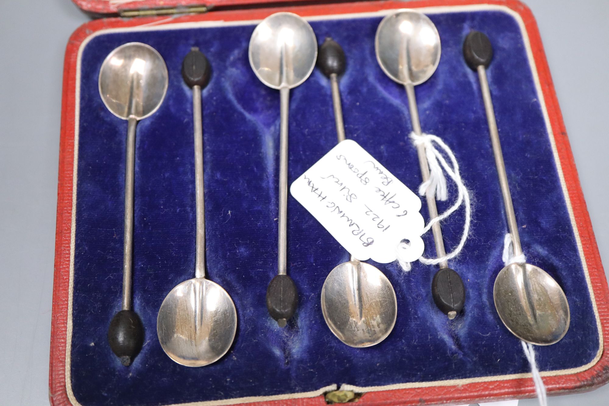 Twelve Victorian silver Apostle coffee spoons and sugar tongs, and three sets of six silver bean end coffee spoons, all cased